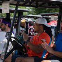 Alumni applauding from golf carts